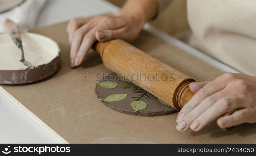 close up hands using rolling pin