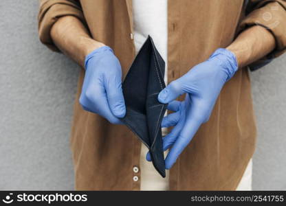 close up hands with gloves holding wallet