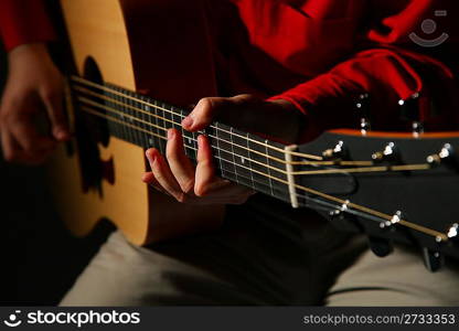 Close-up hands with guitar