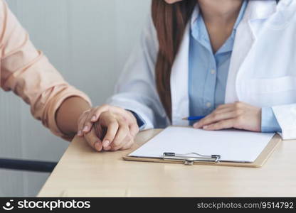 Close up hands Woman doctor holding hands patient encourage cheer up consultation at hospital medicare clinic. Doctor talking to patient support giving hope mental health therapy consoling recovery