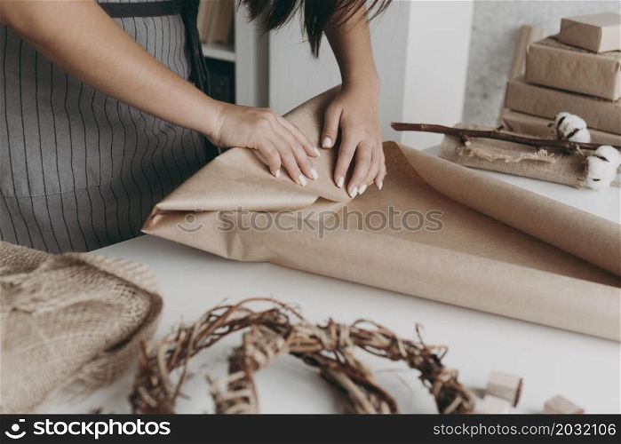 close up hands wrapping paper