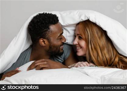 close up happy couple blanket