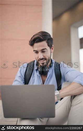 close up happy male tourist using laptop