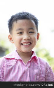 close up headshot of cheerful asian children toothy smiling face of happiness emotion