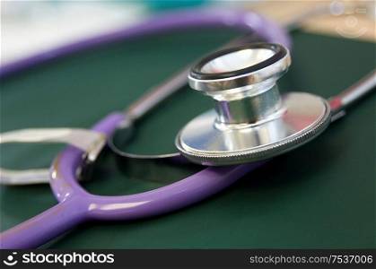 Close-up horizontal view of purple stethoscope.