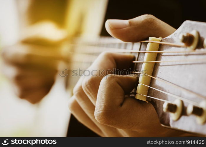 Close up human hand show playing guitar