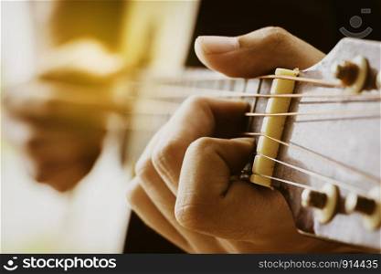Close up human hand show playing guitar