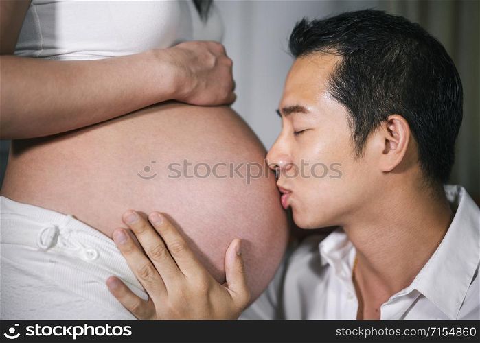 close-up Husband kissing to his wife&rsquo;s belly