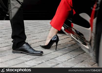 Close up image of a business woman getting out of her car with high heels shoes. Close up image of a business woman getting out of her car with high heels shoes.
