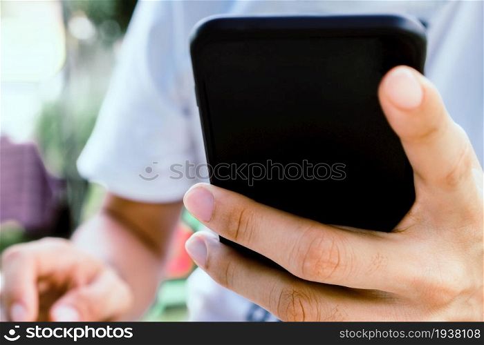 Close up image of a man using mobile smart phone