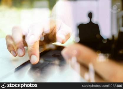 Close up image of a man using mobile smart phone and digital tablet