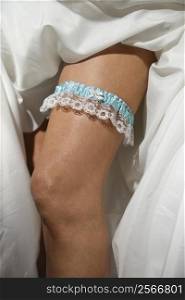 Close-up image of bride&acute;s leg with garter.