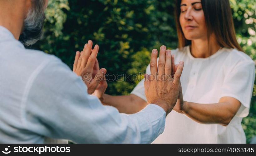 Close up image of instructor&rsquo;s and woman&rsquo;s hands. Reiki healing course, energy healing concept. . Close-Up of Hands on a Reiki Healing Course