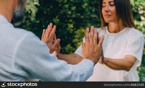 Close up image of instructor&rsquo;s and woman&rsquo;s hands. Reiki healing course, energy healing concept. . Close-Up of Hands on a Reiki Healing Course