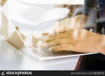 Close up image of Man typing on laptop keyboard