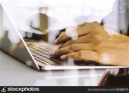 Close up image of Man typing on laptop keyboard