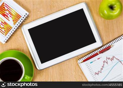 Close up image of tablet pc apple cup of coffee on table. Office workplace