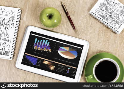 Close up image of tablet pc apple cup of coffee on table. Office workplace