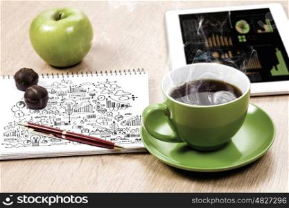 Close up image of tablet pc apple cup of coffee on table. Office workplace