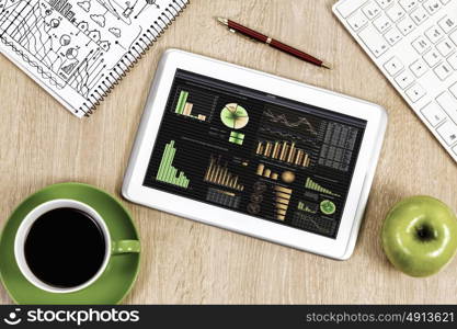 Close up image of tablet pc apple cup of coffee on table. Office workplace