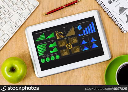 Close up image of tablet pc apple cup of coffee on table. Office workplace