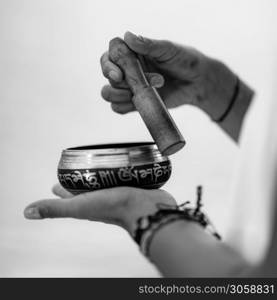 Close up image of woman&rsquo;s hands holding Tibetan Singing Bowl Outdoors