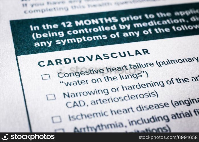 Close up image, selective focus on cardiovascular, heart disease content on health insurance questionnaire and application form. Healthcare, insurance policy, personal safety plan, business concepts.