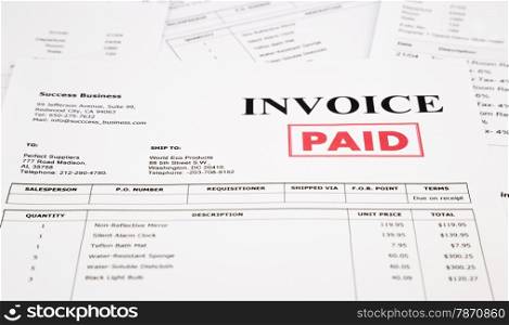 close-up invoice and bills with red paid stamp, document and paperwork