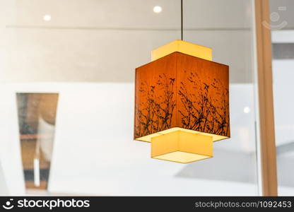 Close up japanese style hanging lamp decorated in restaurant.