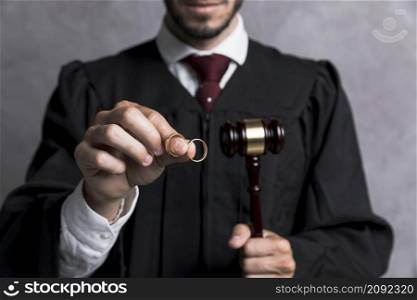 close up judge with golden rings gavel