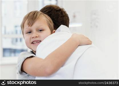 close up kid hugging doctor