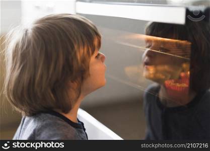 close up kid looking oven