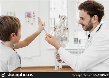 close up kid playing with skeleton