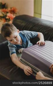 close up kid preparing luggage