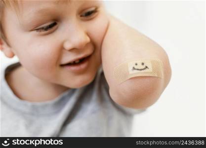 close up kid with smiley patch