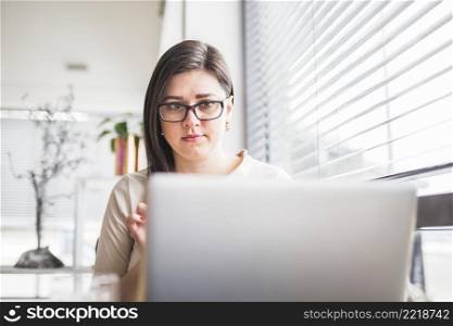 close up laptop front young woman with spectacles