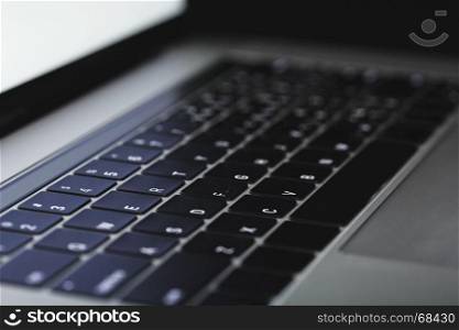 close-up laptop keyboard illuminated on night