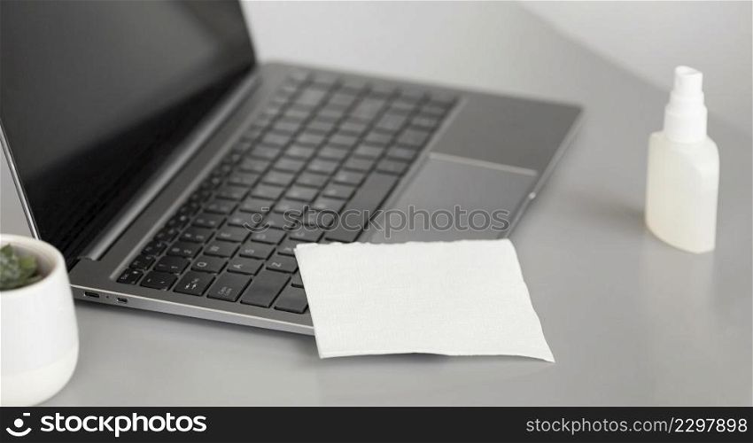 close up laptop with disinfectant office