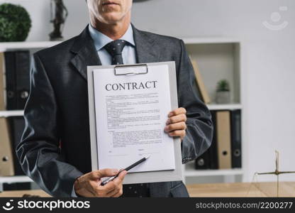 close up lawyer showing legal contract agreement with pen