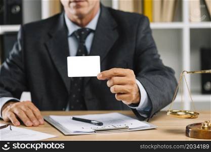 close up lawyer showing white blank card with contract table