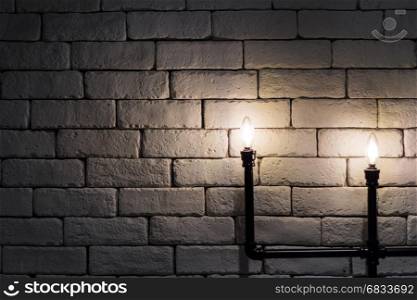 close up light bulb with black pipe on brick background loft style decoration
