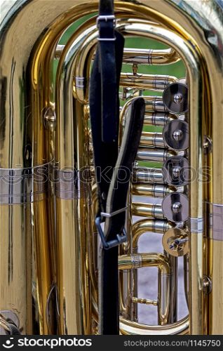 close up lower part of a golden colored shiny tuba