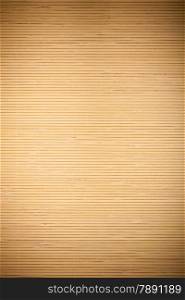 Close up macro of beige brown bamboo mat as striped background texture pattern. Oriental