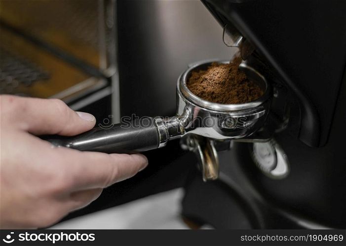 close up male barista using professional coffee machine. Beautiful photo. close up male barista using professional coffee machine