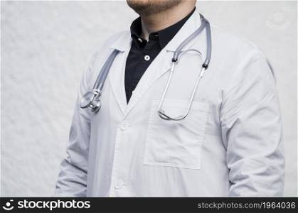 close up male doctor with stethoscope around his neck against white backdrop. High resolution photo. close up male doctor with stethoscope around his neck against white backdrop. High quality photo