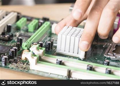 close up male technician hand s installing heatsink computer main board
