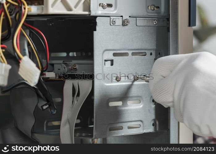 close up male technician hand wearing gloves fixing screw computer slot