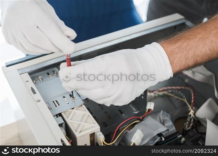 close up male technician hand wearing gloves repairing computer