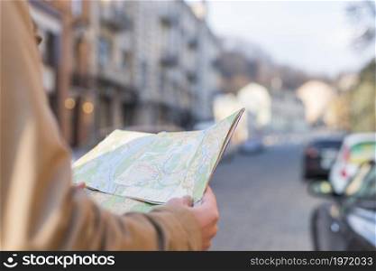 close up male traveler holding map hand standing city street. High resolution photo. close up male traveler holding map hand standing city street. High quality photo