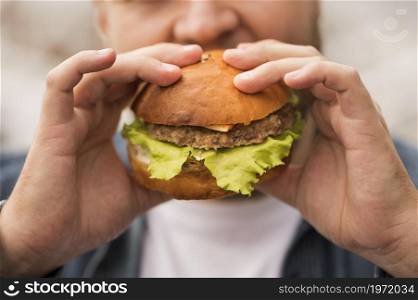 close up man eating burger. High resolution photo. close up man eating burger. High quality photo